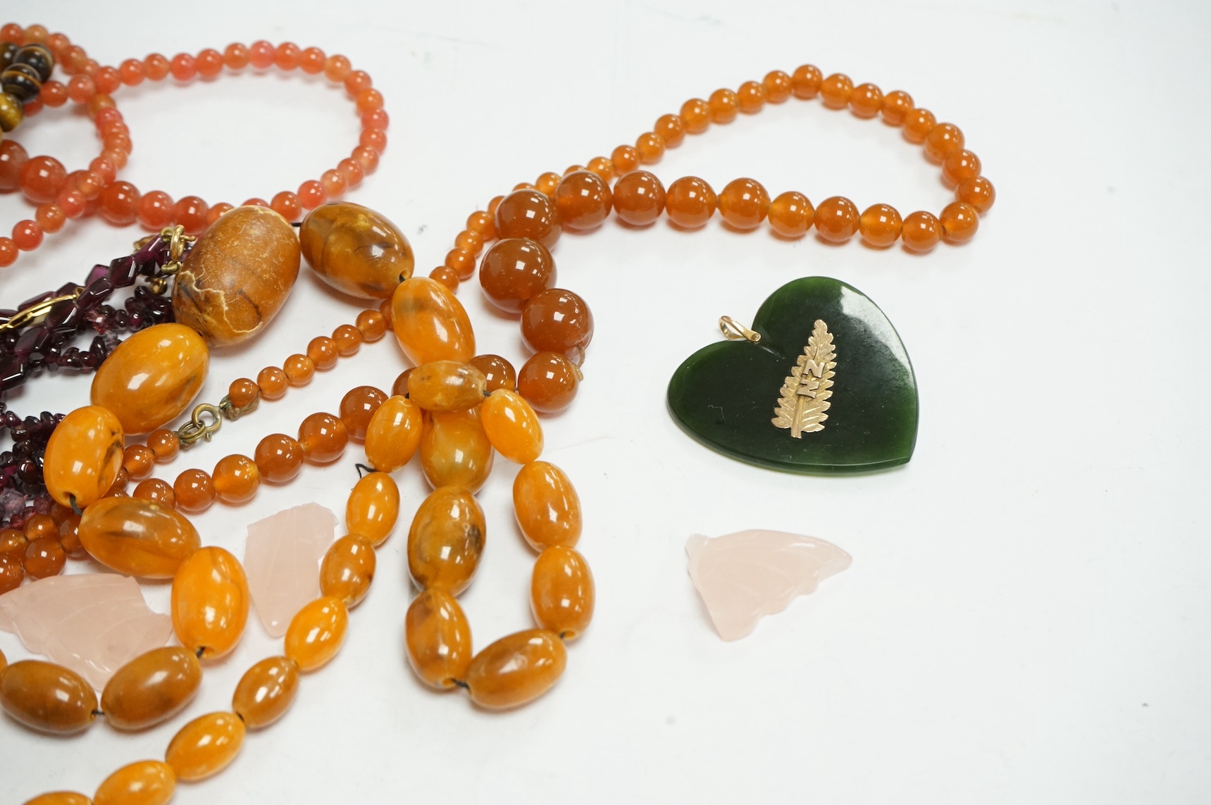 Nine assorted necklaces, including graduated cultured pearl, with 15ct and enamel clasp, 38cm, moss agate, garnet and tiger's eye quartz, etc and two other items, one a.f. Condition - poor to fair to good